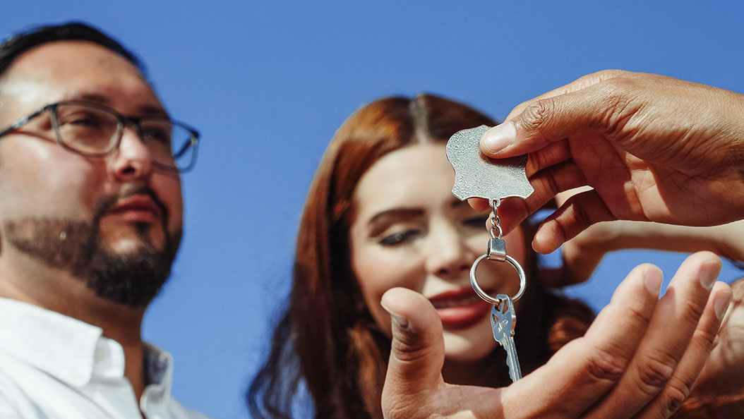 A couple received a house key, up close from a low angle